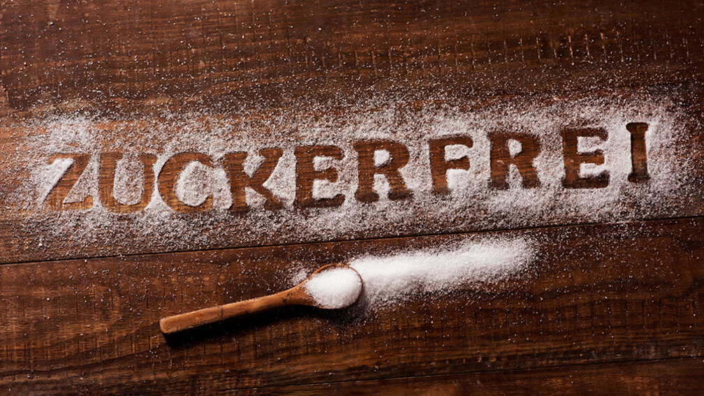 In ausgestreutem Zucker steht das Wort Zuckerfrei