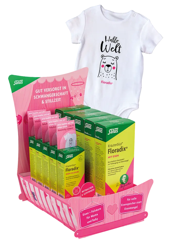 Rosa-grünes HV-Display für das Arzneimittel Floradix als Aktionsformat mit passendem Babybody als Aktionsgeschenk