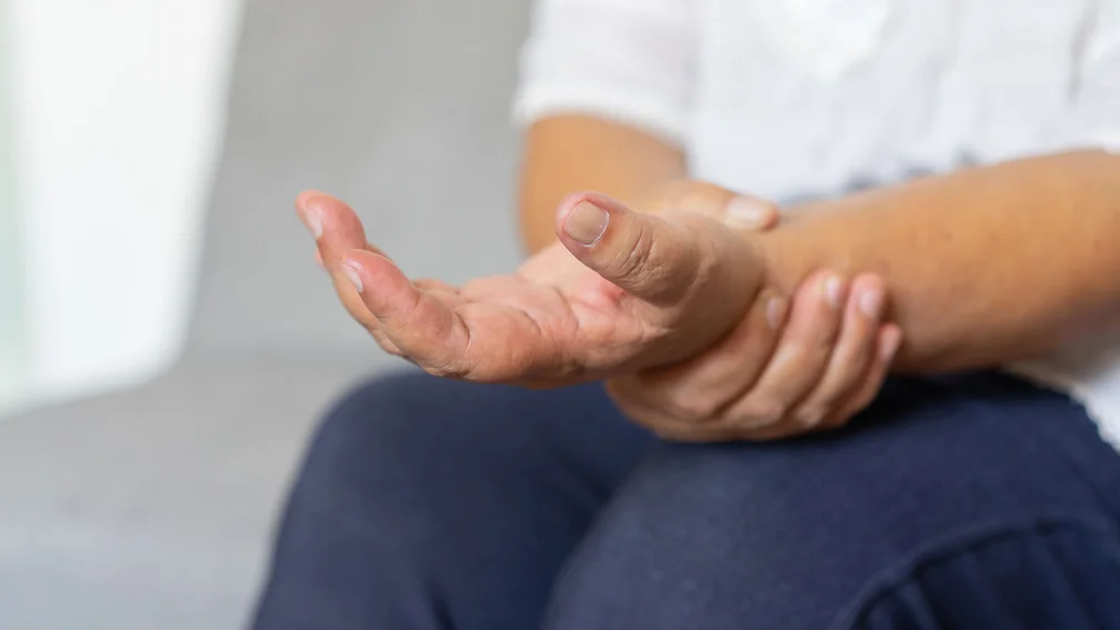 Frau hält ihre Hand fest